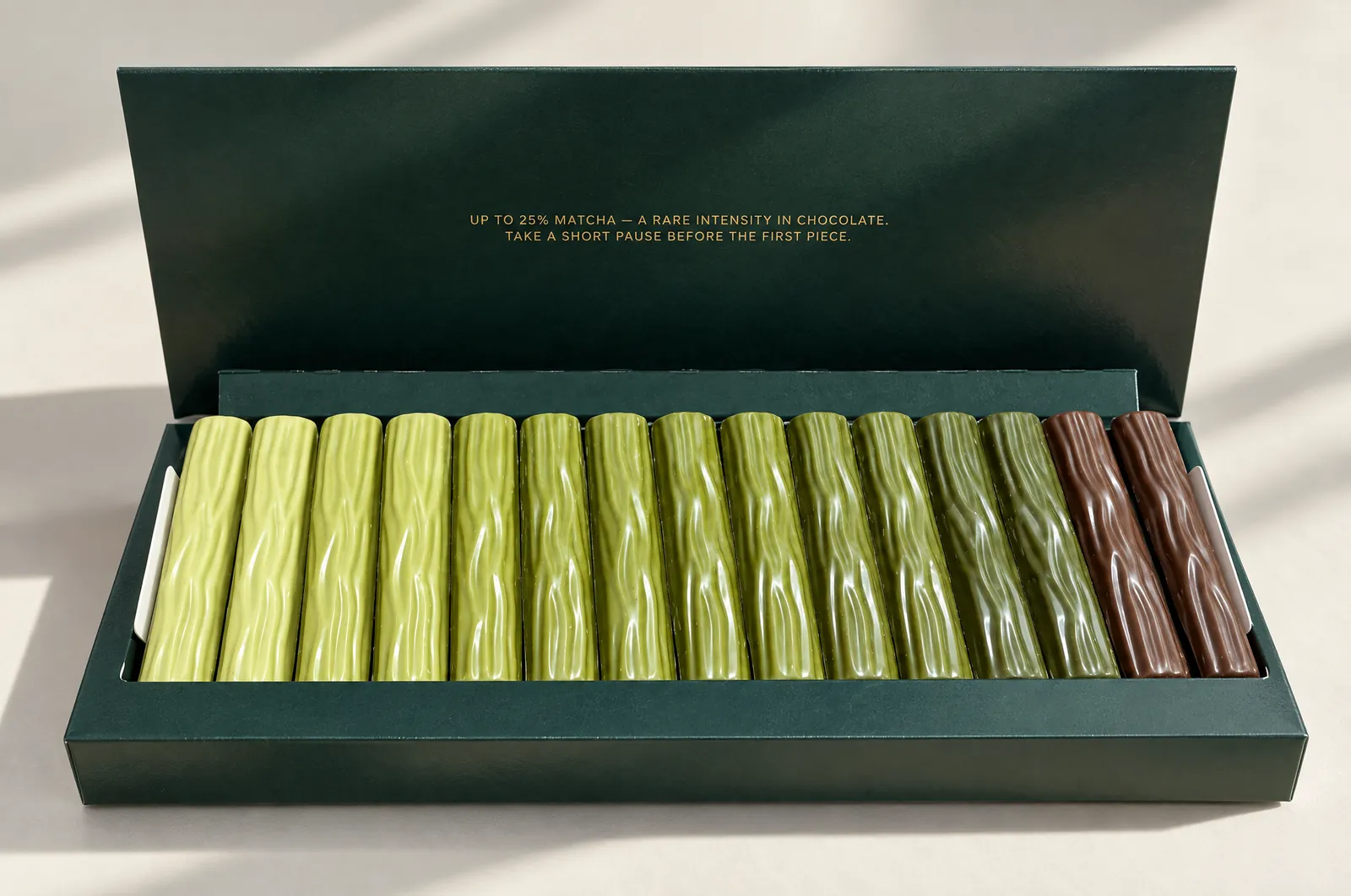 7 Shades of Matcha: sixteen matcha chocolate sticks in an open green box, from light green to hojicha